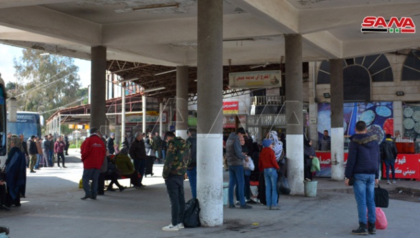 Civilians waiting near the bus platform to Homs, which resumed operation (SANA, February 23, 2020)