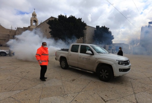 Employees of the Bethlehem city hall disinfect the area in front of the Church of the Nativity (Wafa,, March 7, 2020).