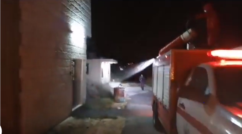 Civil defense forces disinfecting the home of a Beit Ula resident who was found to be infected with the virus (Beit Ula Facebook page, May 16, 2020)