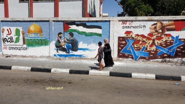 Mural in Rafah. From left to right, al-Aqsa mosque with a sign reading "No annexation," mask-wearing Palestinians plant a Palestinian flag on an Israeli flag, a fist smashes houses representing the Israeli communities in Judea and Samaria and "No annexation" (Twitter account of journalist Hassan Twitter account of journalist Hassan Aslih, July 1, 2020).