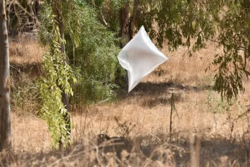 Neutralizing incendiary balloons found in a farm in the western Negev (Israel Police Force spokesman's unit, August 18, 2020). 