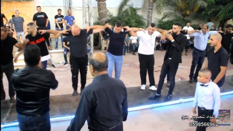 Guests dance during a wedding on the Palestinian side of Barta'a. No masks and no social distancing YouTube, October 22 and 23, 2020).