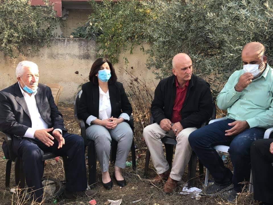 A Fatah delegation sits with the family near the ruins of the house. Few masks, no social distancing (Rujeib Facebook page, November 2, 2020).