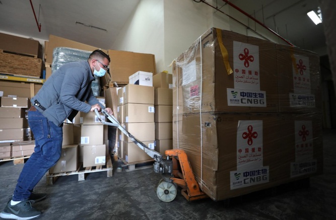 Storing China-donated Sinopharm vaccines in the logistic warehouses east of Nablus (Wafa, March 29, 2021).