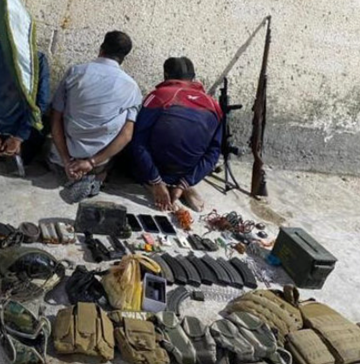 Detained ISIS operatives and some of the weapons found in their possession. 