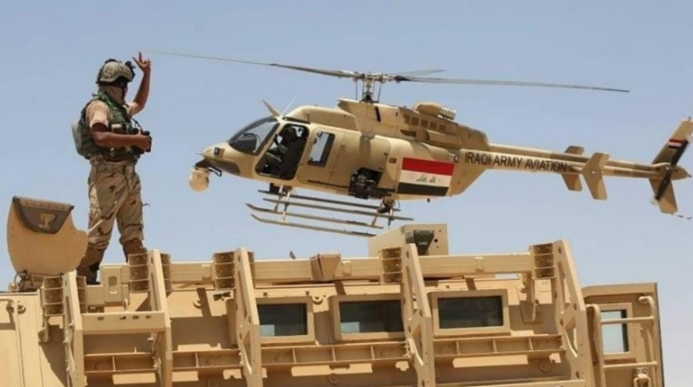 Iraqi army helicopter and armored vehicle during security activity (Al-Sumaria, August 17, 2021)