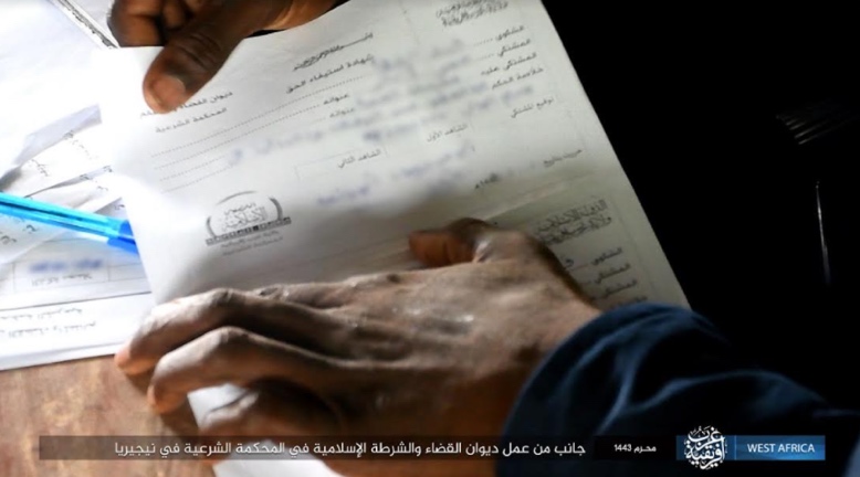 An official holding a legal document at the Bureau of Justice and Islamic Police in ISIS’s sharia court in Nigeria (Telegram, August 23, 2021).