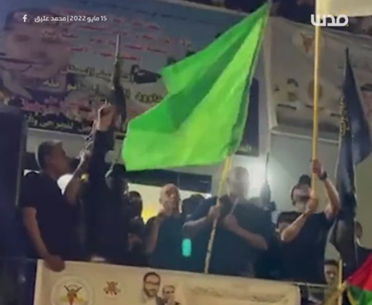 The father of terrorist Raad Hazem holds a Hamas flag during a demonstration in the Jenin refugee camp (QudsN Twitter account, May 15, 2022). 