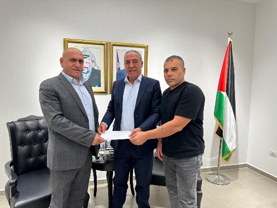 Hussein al-Sheikh gives the governor of the Jenin district the grant from Qatar (Hussein al-Sheikh's Twitter account, June 24, 2023).