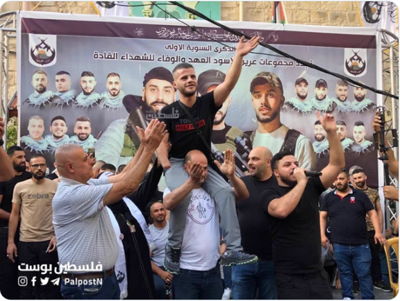 Akrama al-Khamash, a wounded Lion's Den operative, carried on the shoulders of a supporter at the ceremony (@haneenhallabii Twitter account, July 28, 2023).