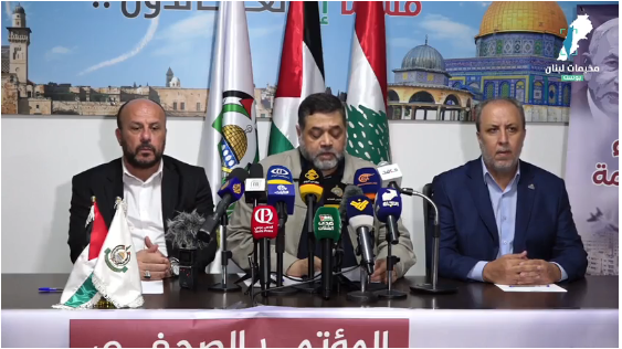 Hamdan sits in the middle at the press conference. To his right is Hamas spokesman Jihad Tahe, to his left the Hamas representative in Lebanon, Ahmed Abd al-Hadi (Facebook page CampsPostPlus, October 21, 2023)