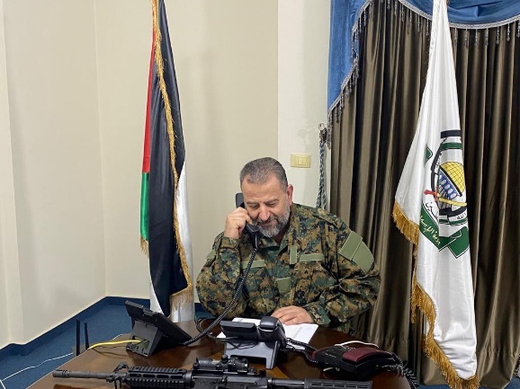 Photos of Saleh al-Arouri in uniform with an M-16 rifle on his desk, published in response to the Israeli prime minister's threat (Shehab, August 27, 2023)