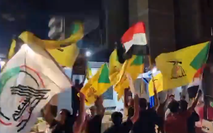 Flags of Iraq, Kataeb Hezbollah, and the Popular Mobilization waved in front of the Iranian embassy in Baghdad (Jafar’s X account, April 14, 2024).