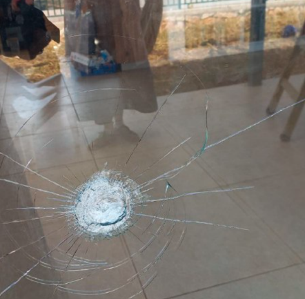 The bullet hole in the window of a house in Kibbutz Merav (QudsN X account, April 21, 2024)