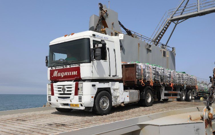 Trucks with humanitarian aid on the floating sea pier off the coast of Gaza (CENTCOM X account, May 17, 2024) 