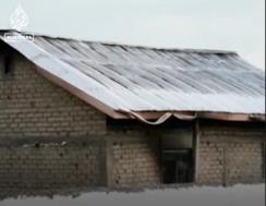 The entrance to the school and a partially burned residential building following the attack (al-Jazeera, June 17, 2023)