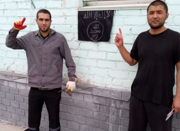 Two of the terrorists in the prison in Volgograd, with an improvised ISIS flag hanging on the wall behind them (al-Nabā’, August 29, 2024)