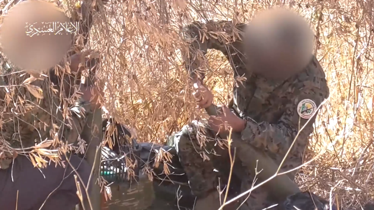 Izz al-Din Qassam Brigades terrorist operatives in Lebanon attach fuses to rockets before firing.