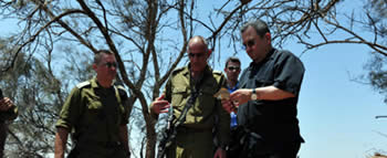 Israeli Defense Minister Ehud Barak visits the site of the attack (Picture from the Ministry of Defense, August 6, 2012).