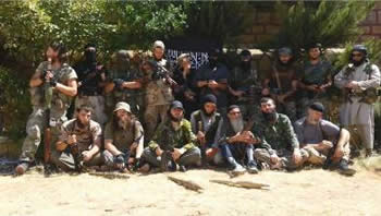 Foreign fighters from the Caucasus (mainly Chechens) in Syria against a background of Al-Qaeda flags (http://fisyria.com, August 3, 2013).  